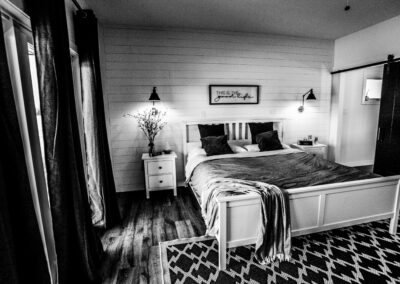 Bedroom With Large Windows Built By Hillside Construction. Building Custom Homes, Cabins, and Renovations in Manitoba and Kenora.