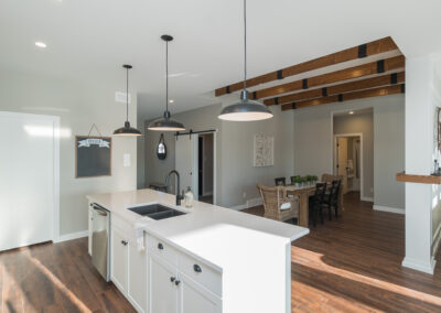 Kitchen With White Counter Tops and Wood AccentsBuilt By Hillside Construction. Building Custom Homes, Cabins, and Renovations in Manitoba and Kenora.