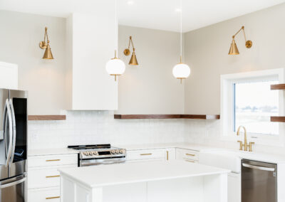 Custom Kitchen Built By Hillside Construction. White and Gold Kitchen With Open Wooden Shelves. A Clean Kitchen Look With Great Accent Pieces.